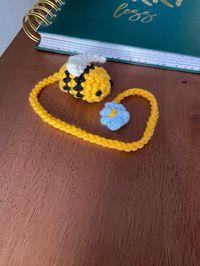 Handmade bee bookmark! Beautiful crochet bookmark as a gift for yourself or a loved one!  Thoughtful gift for a book lover or bee lover or both!  Fits nicely into the groove of a book and less likely to fall out than a paper bookmark!  Also great as a car hanging or a bag accessory!  Length that goes within the book is 9inches/23cm. Let me know if you want a different length!  Made from 100% cotton yarn and some stuffing, this bookmark is extemely durable and adorable!  Thank you for shopping at