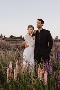 The ultimate adventure elopement day in New Zealand! Sunrise in the lupin fields at Lake Tekapo and exploring the Clay Cliffs in Omarama.