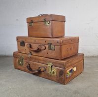 Vintage Leather Pendragon Trunk, Set of 3 rare leather suitcases, brown antique luggage suit cases with a and has a stunning deep glow to the mid brown leather. Exquisite antique vanity case and 2 big trunks oozing with old world charm and telling tales first class travel around a different world. In very good condition. Beautiful brown leather suitcase in excellent original condition. Sizes per suit case: 1: 66x38x19cm 2: 56x35x17cm 3: 33x21x19cm Super quality English leather vintage suitcases.