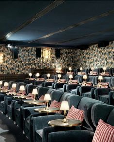 rows of chairs with lamps on them in front of a wallpapered wall and ceiling