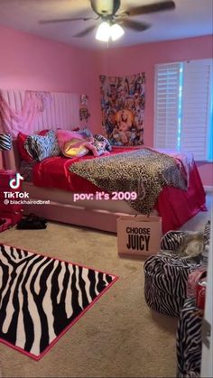 the bedroom is decorated in pink and zebra print