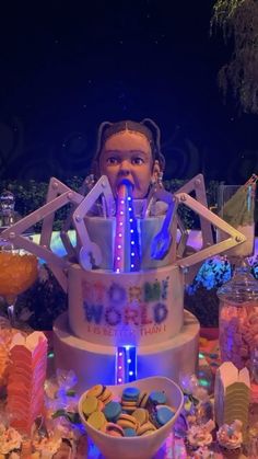 a large cake that is sitting on top of a table with candy and candies