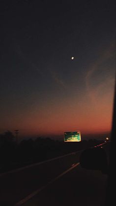 the sun is setting over an empty highway