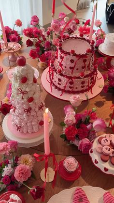 a table topped with lots of cakes and cupcakes