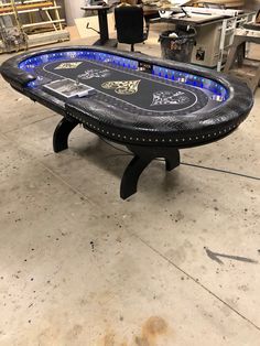 a black table sitting on top of a floor in a room filled with other items