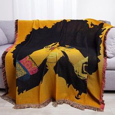 a couch with a yellow and black blanket on it