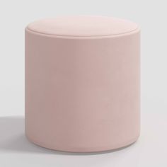 a pink stool sitting on top of a white floor