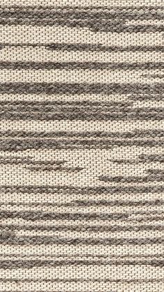 an area rug with grey and white stripes