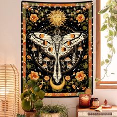 a tapestry hanging on the wall next to a potted plant