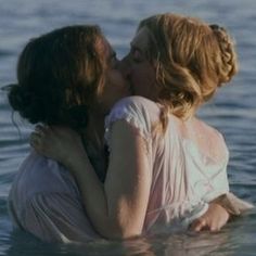 two women in the water kissing each other