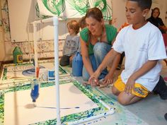 two children and an adult working on art project