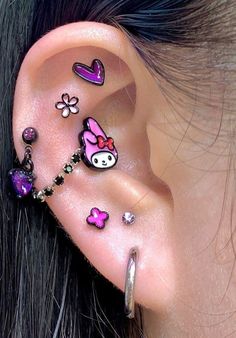 an ear with many different designs on the inside of it and some charms attached to it