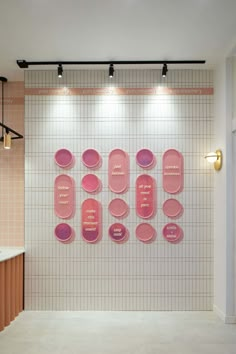 there are pink plates hanging on the wall