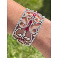 This is part of Chairish’s Fine Jewelry assortment.  Experience the unmatched beauty and sophistication of this Art Deco ruby and diamond filigree bracelet. Meticulously crafted with timeless elegance, this luxurious piece showcases 35 carats of rubies and 11 carats of diamonds set in a dynamic floral motif. Featuring 36 vivid red marquise-cut rubies and 268 sparkling round-cut white diamonds, each stone carefully selected for its exceptional quality and brilliance. The bracelet is made of 18k w Luxury Ruby Diamond Bracelet For Formal Occasions, Luxury Diamond Bracelet With Intricate Design, Luxury Ruby Bracelets, Luxury Round Ruby Bracelet, Luxury Round Ruby Bracelets, Formal Red Diamond Bracelet, Luxury Ruby Diamond Bracelet, Luxury Red Diamond Bracelet For Formal Occasions, Luxury Diamond Bangle Bracelet With Intricate Design