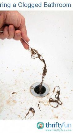 a person is holding a plunger over a sink that has been filled with water