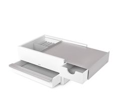 an open drawer on the side of a white table