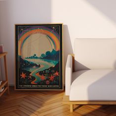 a white chair sitting next to a poster on a wall in a room with wooden floors