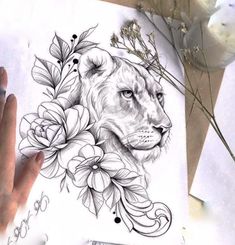 a drawing of a lion with flowers on it's face and hands next to paper