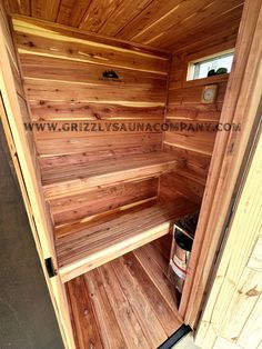 the inside of a sauna with wood paneling on the walls and floor is shown