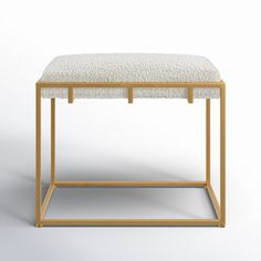 a white and gold stool with a square seat