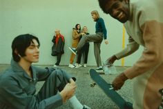 a group of young men standing next to each other with skateboards in their hands