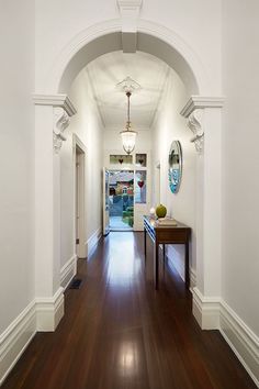 the hallway is clean and ready for guests to use it as an entrance way in this house