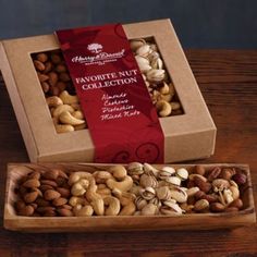 two boxes filled with nuts sitting on top of a wooden table