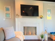 a living room filled with furniture and a flat screen tv mounted above the fire place