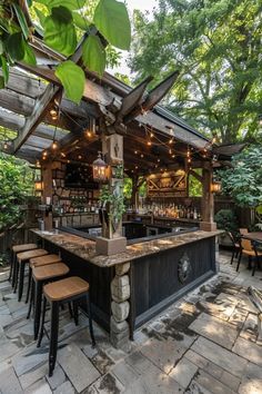 an outdoor bar with stools and lights