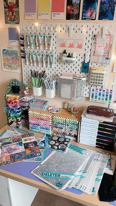 the desk is full of art supplies and stationery