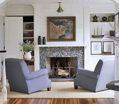 a living room filled with furniture and a fire place in the middle of a room