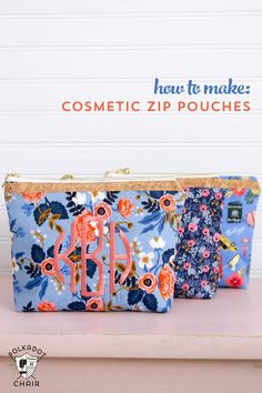 two personalized cosmetic bags with flowers and monogrammed letters on them, one is blue