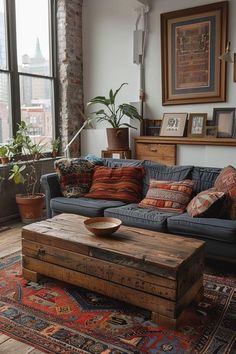 a living room with a couch, coffee table and potted plant in the corner