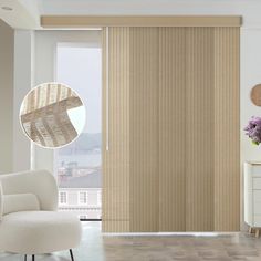 a living room with white furniture and wooden blinds on the sliding door, in front of a large window