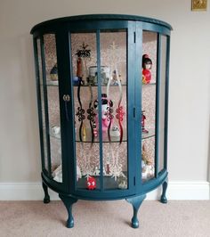 a blue china cabinet filled with lots of toys