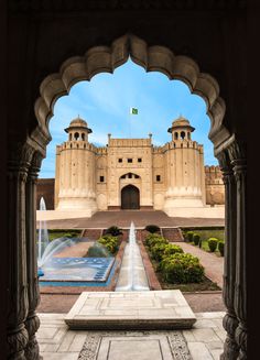 the entrance to an old castle with water fountain in front of it stock photo