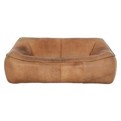 a brown leather dog bed on a white background