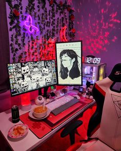 two computer monitors sitting on top of a desk next to each other in front of a purple wall