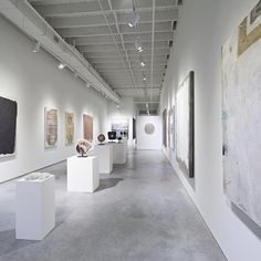 an art gallery with paintings and sculptures on display