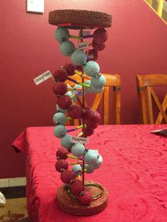 a table topped with a red cloth covered tablecloth and lots of balls on top of it