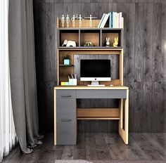 a desk with a computer on top of it in front of a wooden paneled wall