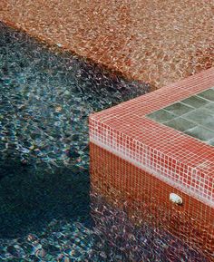 a red and white tiled box sitting on top of a pool