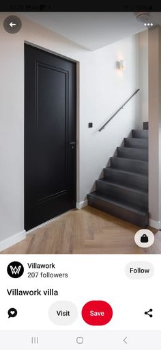 the door is open and there are two black doors on each side of the stairs