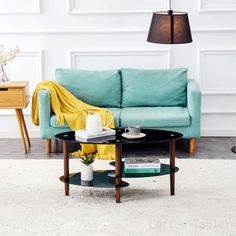 a living room with a blue couch and coffee table