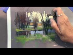 someone is painting trees and water with colored pencils