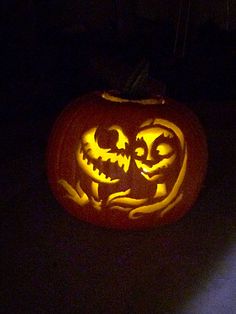 a carved pumpkin with two faces on it