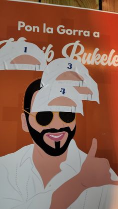 a poster with a man's face wearing sunglasses and pointing to his left side