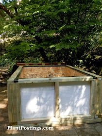 an outhouse built into the ground in front of some trees