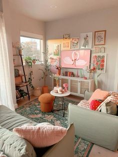 a living room filled with lots of furniture and pictures on the wall above it's windows