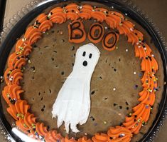 a cake decorated with icing and sprinkles that says boo on it